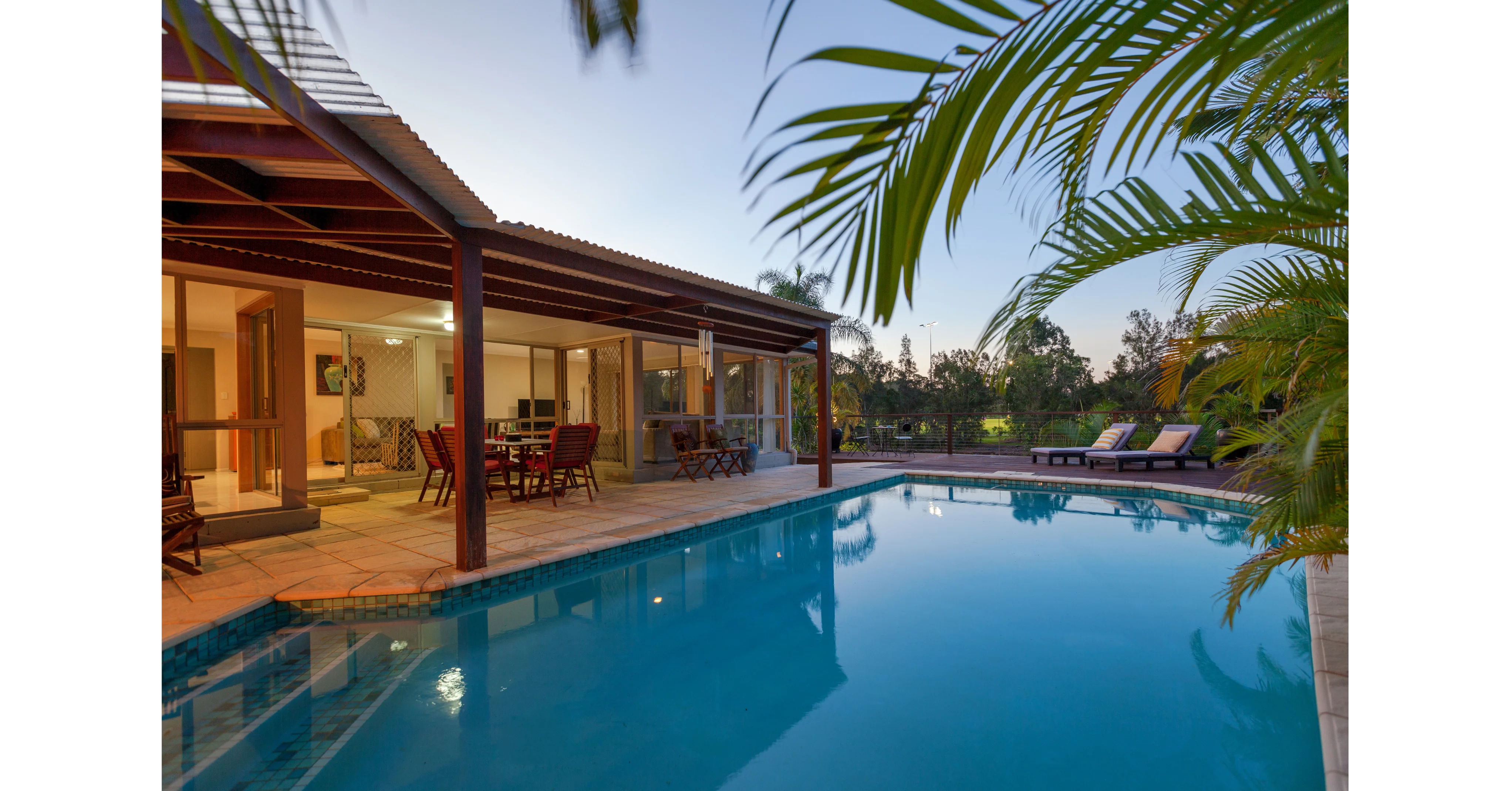 Beautiful Australian backyard pool at dusk in {location.name}