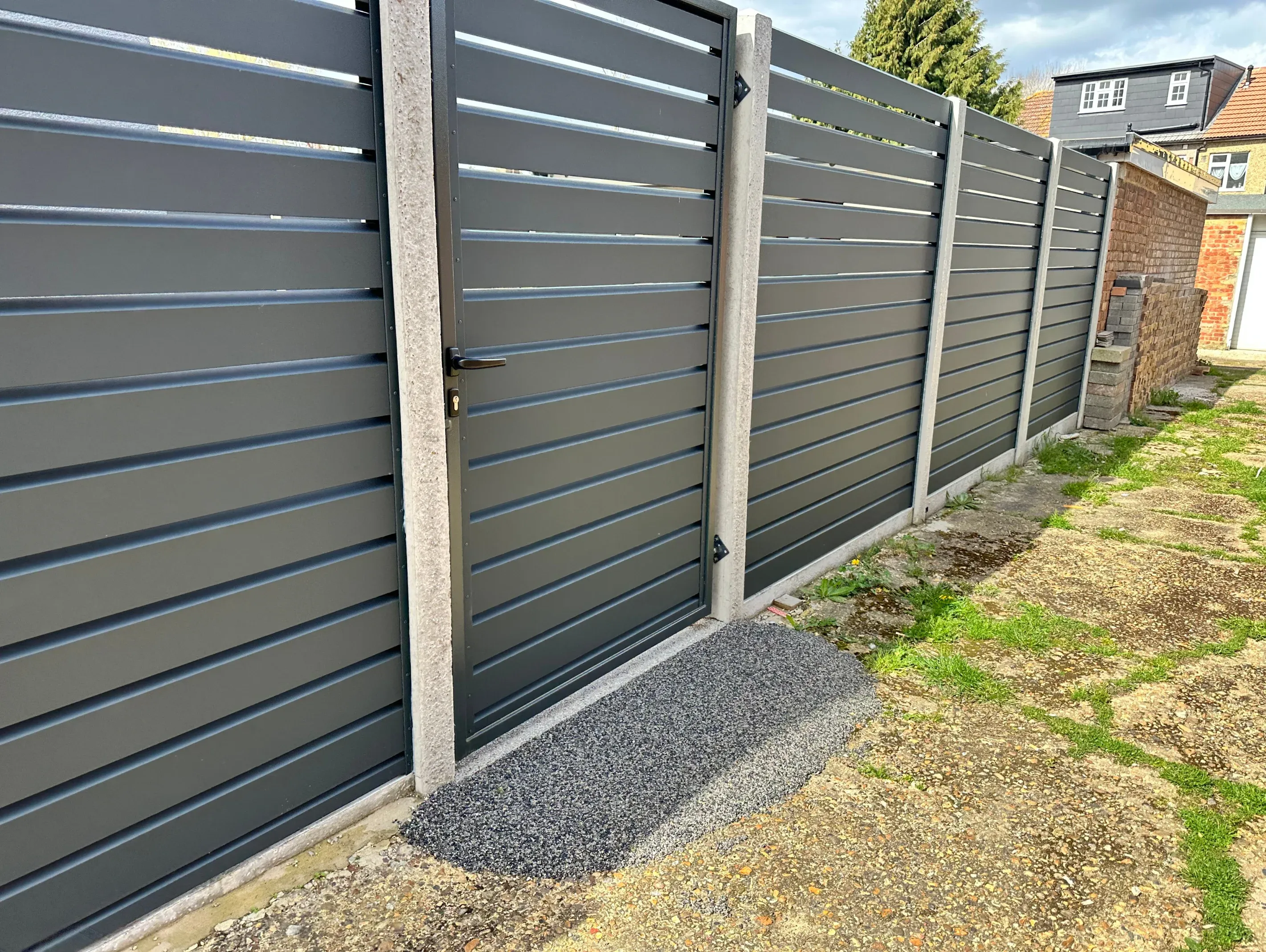 Modern aluminium slat fence with matching gate