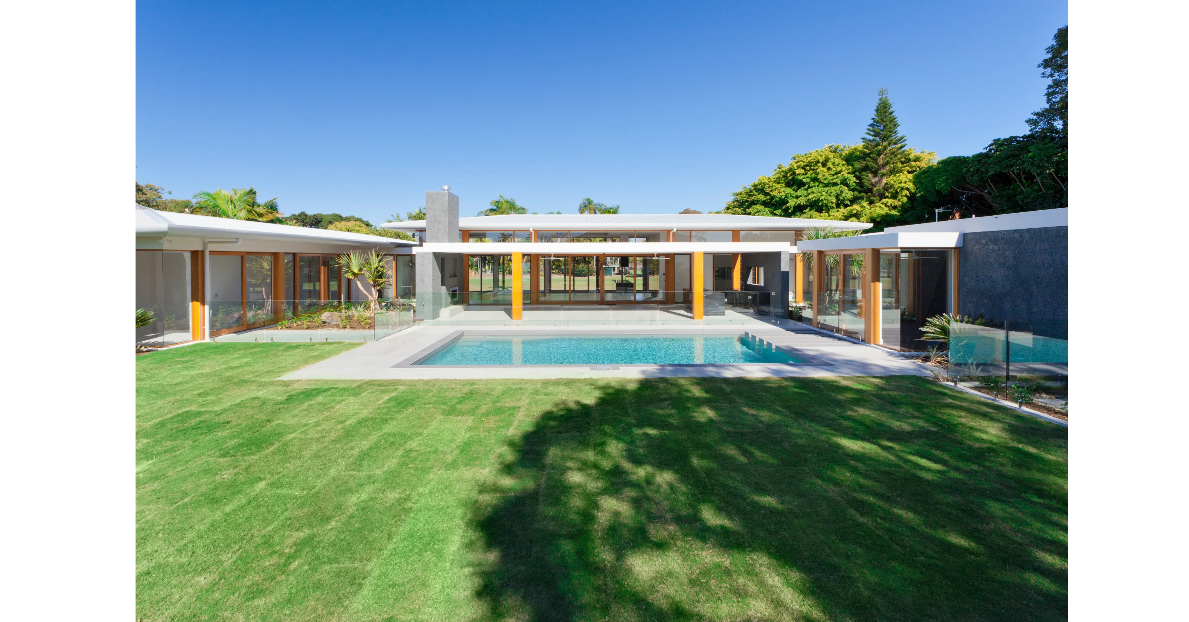 Rectangular concrete pool with glass fencing - Australian pool installation
