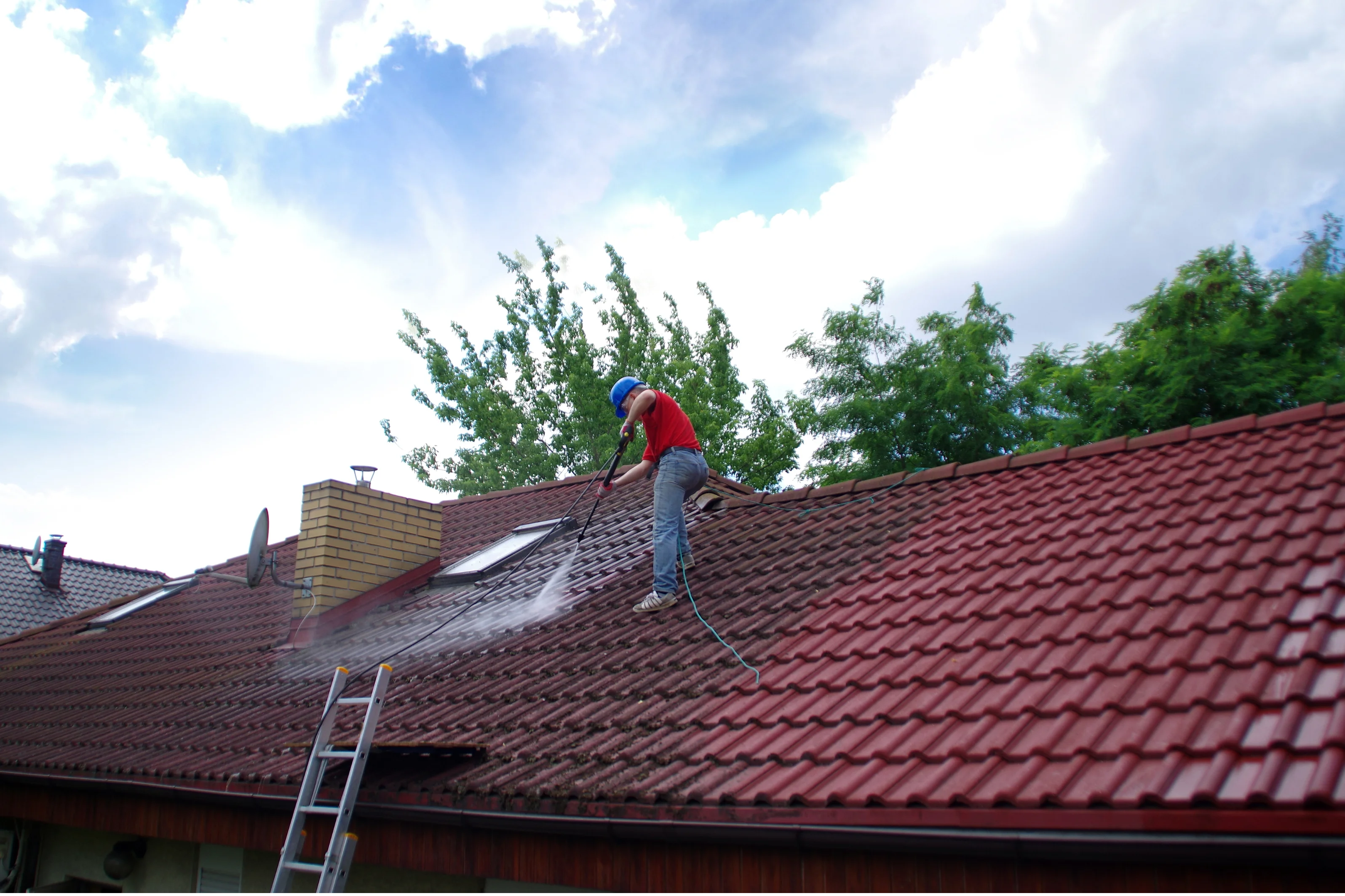 Professional high-pressure roof cleaning in progress on Perth tiled roof